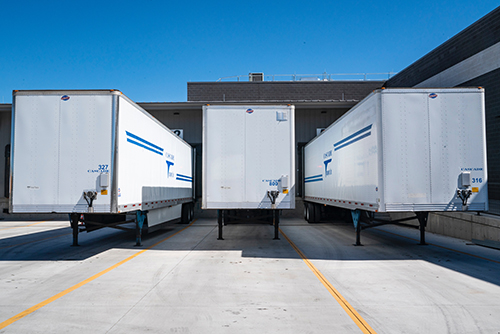 Image of a row of tractor trailer containers